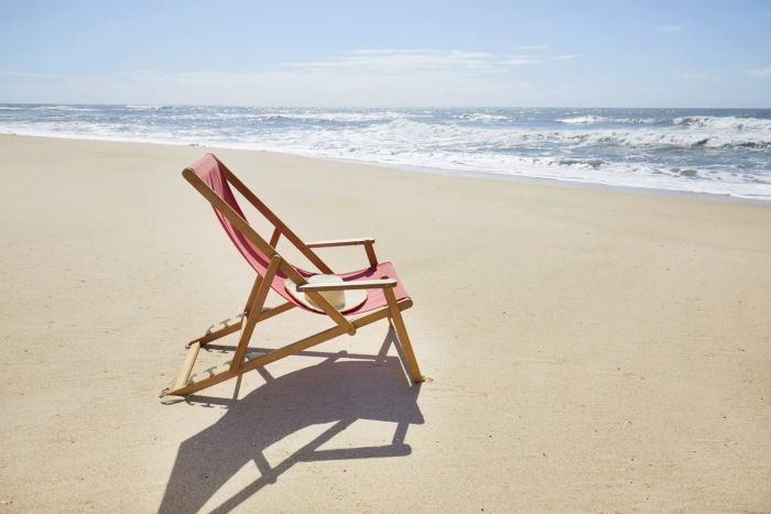 Lonely beach chair by the ocean