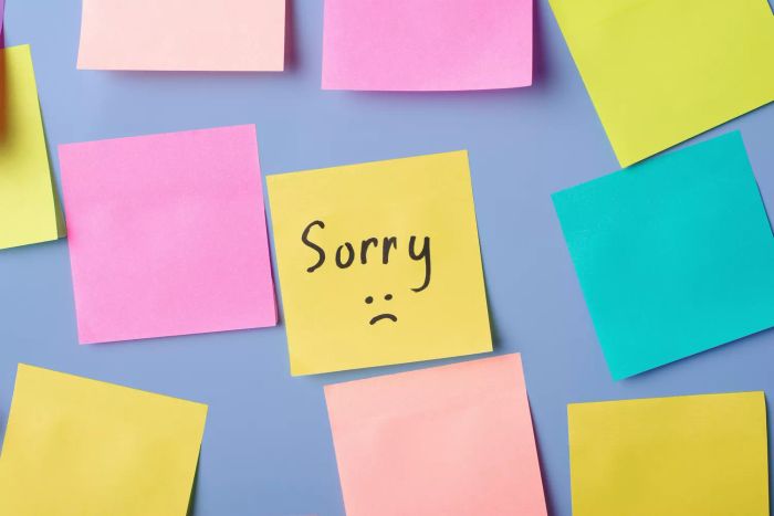 a sticky note displaying the word sorry