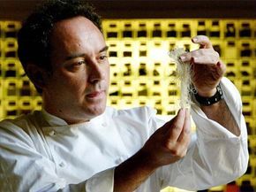 Chef Ferran Adrià holding a yarn-like substance in his hands