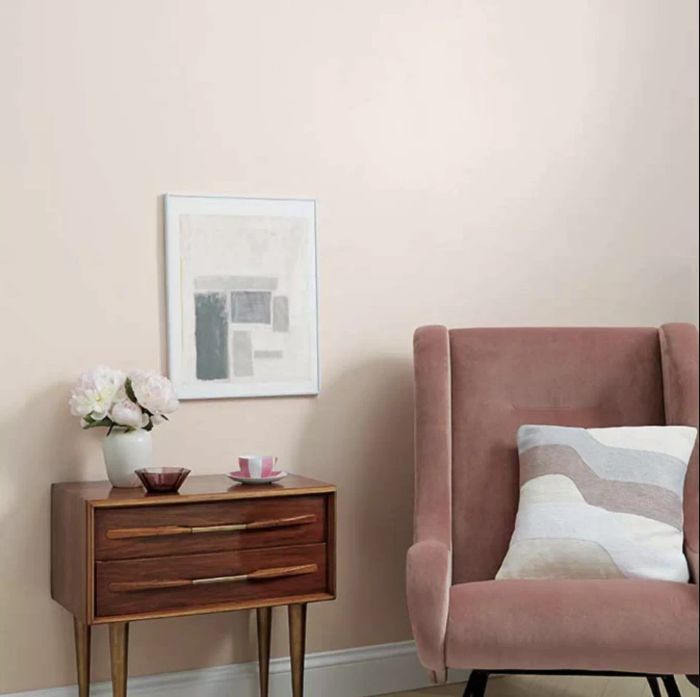 A soft pink paint, Wing It by Clare, paired with a side table and chair