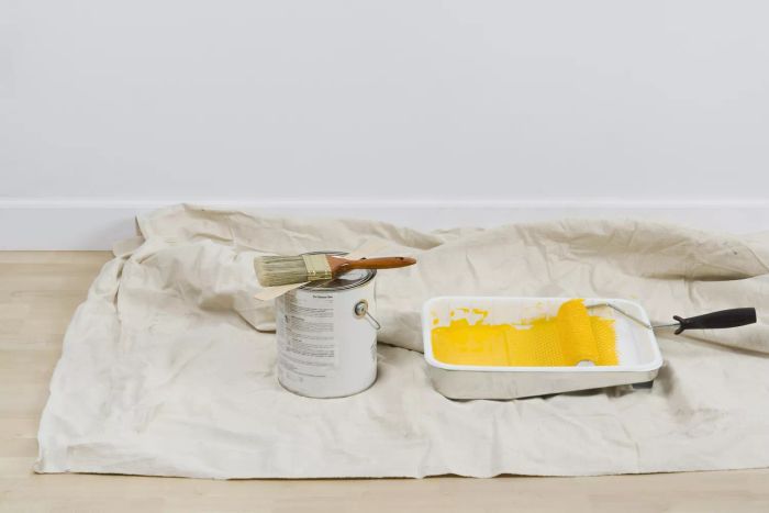 How to Apply Paint to a Ceiling Using a Tarp
