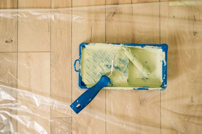paint roller resting in tray