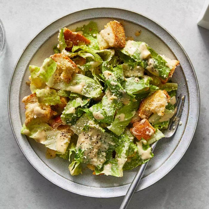 Overhead View of Miso Caesar Salad in a Bowl with a Metal Fork