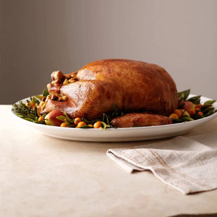 A turkey dish with autumn-themed decorations on a table