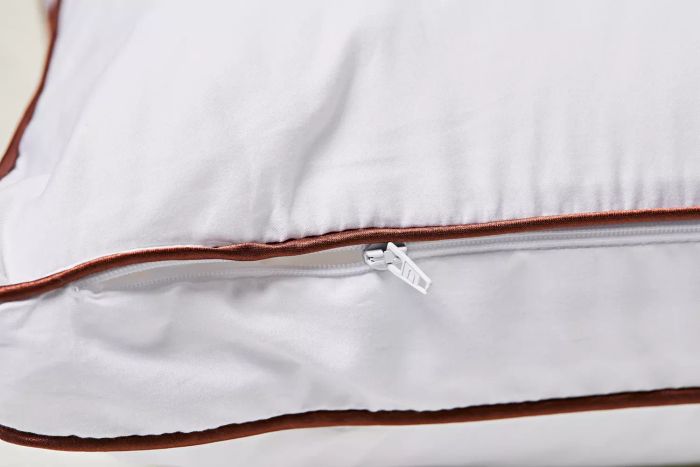A detailed close-up of the zipper on the Saatva Latex Pillow