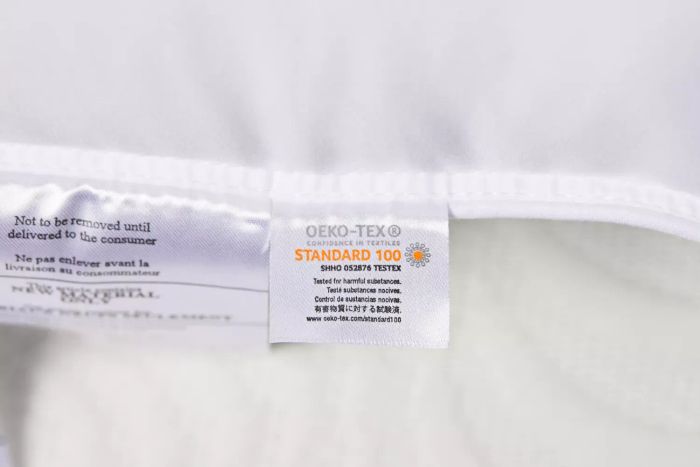 A close-up view of the instruction label on the Amazon Basics Down-Alternative Pillow