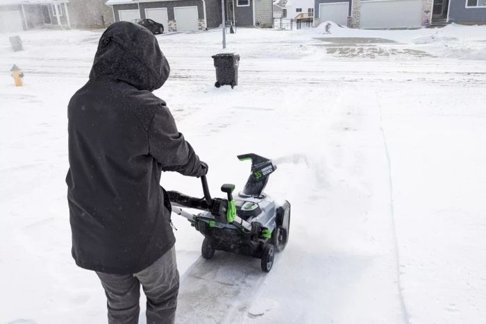 Person clearing snow using the EGO Power+ 21-Inch Cordless Single-Stage Snow Blower