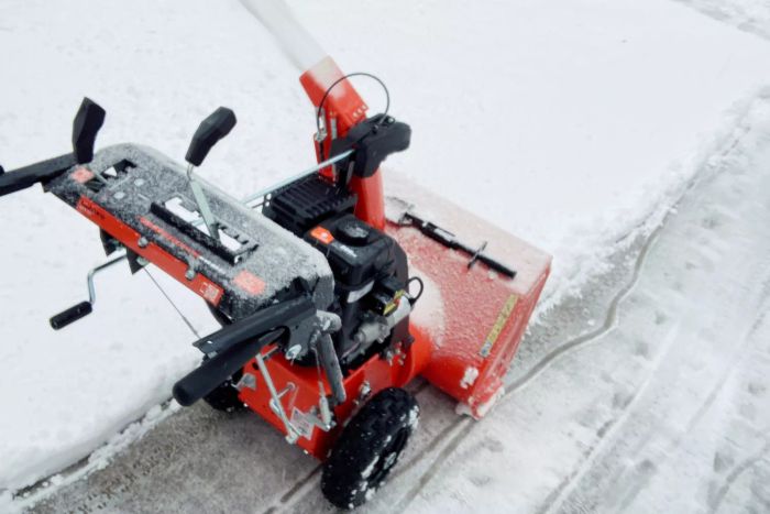 The Ariens Classic 2-Stage 24-Inch Snow Blower effectively clears snow from pavement.