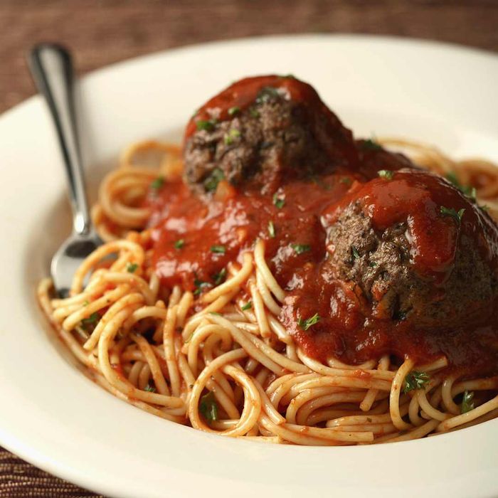 Close-up view of spaghetti served with meatballs.