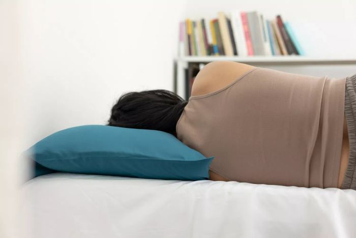A person lying on the Slumber Cloud Core Down Alternative Pillow