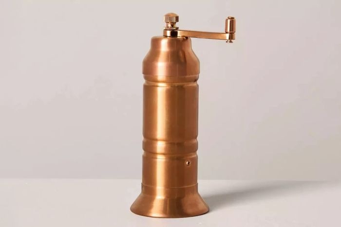 The Target Hearth & Hand with Magnolia Salt and Pepper Crank Grinder features a stylish copper finish and offers a practical, easy way to season your meals with freshly ground spices.