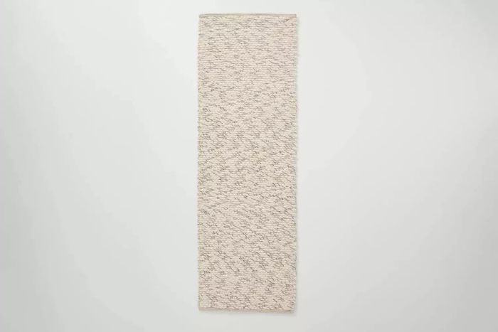 The Target Hearth & Hand with Magnolia Chunky Rectangular Handmade Woven Area Rug is a perfect addition to any room, adding both style and texture. This rug features a flat-pile design with a cotton backing, available in a soft cream color. It's ideal for high-traffic areas, and the 5x7 size works wonderfully in most bedrooms and offices. It’s also available in runner, accent rug, and large 7x10 sizes. One reviewer shared, 'It’s a gorgeous staple piece in our living room and really ties the whole space together.'