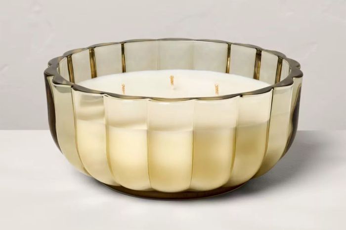 The Target Hearth & Hand with Magnolia Tinted Glass Salted Honey Scalloped Jar Candle offers a delightful blend of elegance and warmth, with a soft glow and the comforting scent of salted honey.