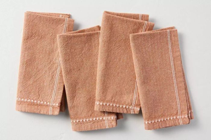 The Target Hearth & Hand with Magnolia 4pk Textured Stripe Border Cloth Napkins combine practicality with style, adding a sophisticated look to your dining table with their textured striped design.