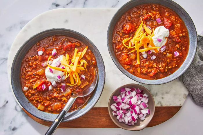 texas chili in bowls with onions and cheese