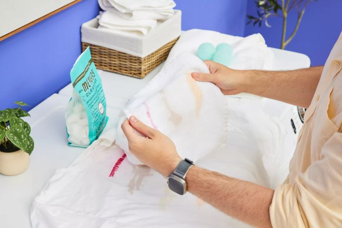 A person is holding a cloth that has been washed using Mrs. Meyer’s Clean Day Laundry Detergent Pacs.