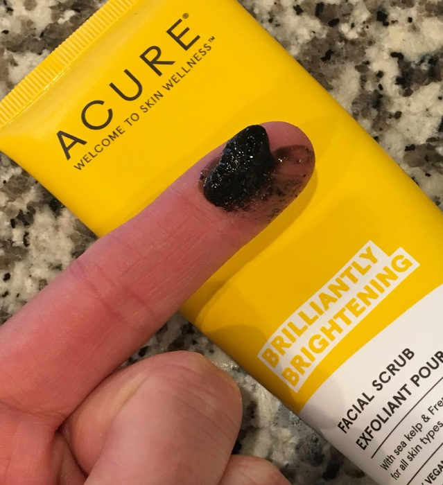 A reviewer with a small amount of the product on their finger