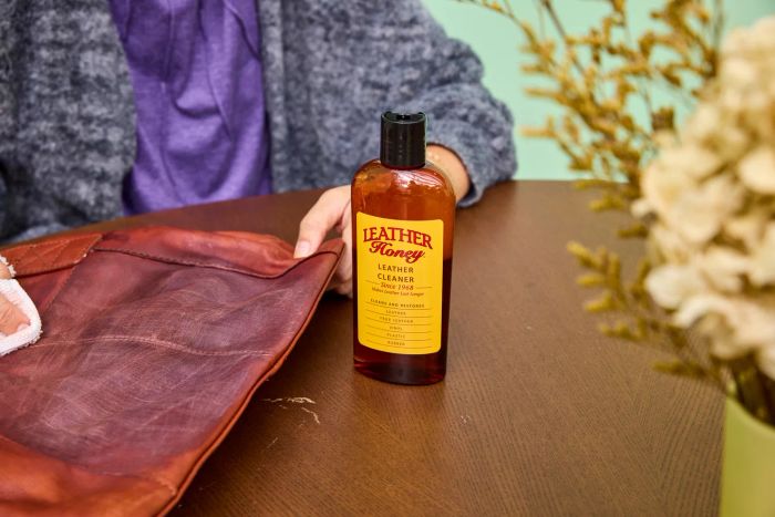 A bottle of Leather Honey Leather Cleaner placed on a table