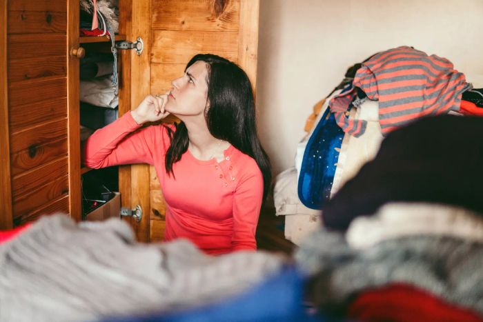 Woman evaluating wardrobe 