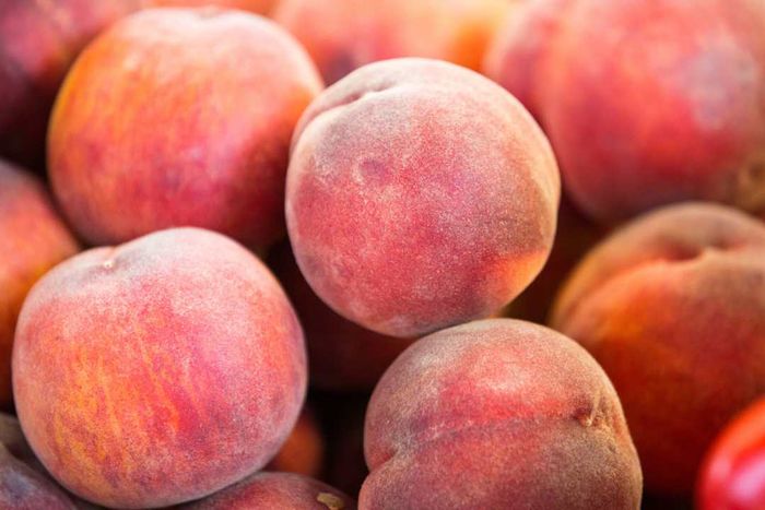 A market display of fresh peaches