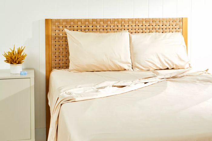 Bed adorned with the Lands' End 400 Thread Count Premium Supima Cotton No Iron Sateen Bed Sheet Set, positioned next to a cabinet