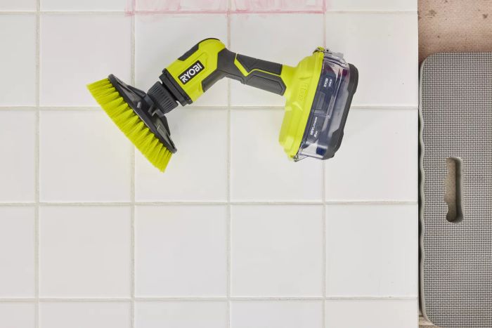 Ryobi ONE+ 18V Cordless Compact Power Scrubber Kit placed on a white tile floor