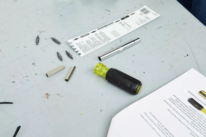 Close-up of Klein Tools 11-in-1 Screwdriver and Nut Driver components on a white surface
