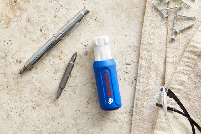 Lenox 9-in-1 Rubber Handle Multi-Bit Screwdriver Set components placed on a beige surface beside a cloth