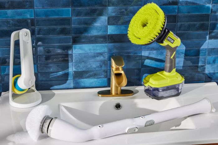 Three electric scrubbers positioned on a sink featuring a blue backsplash