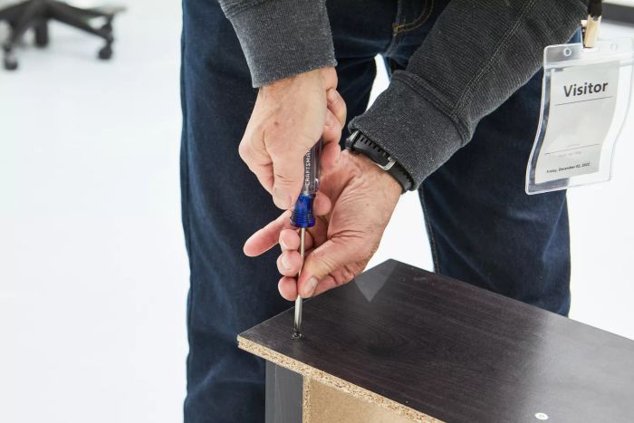 Close-up of a person tightening a screw using the Craftsman 5-Piece Screwdriver Set on wood
