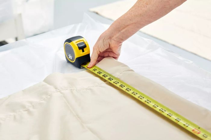Person measuring the Lands' End 400 Thread Count Premium Supima Cotton No Iron Sateen Bed Sheet Set with a tape measure