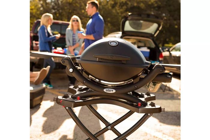 A Weber Q1200 Gas Grill at an outside gathering
