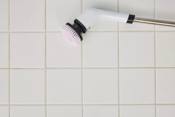A Losuy Electric Spin Scrubber rests on white tile