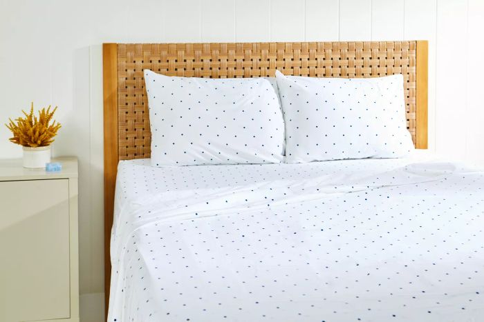 Bed dressed with sheets and pillows from the California Design Den Cotton Sateen Sheet Set