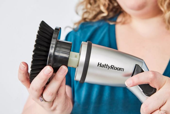 A person holds the head of a HattyRoom Rechargeable Cordless Electric Spin Scrubber