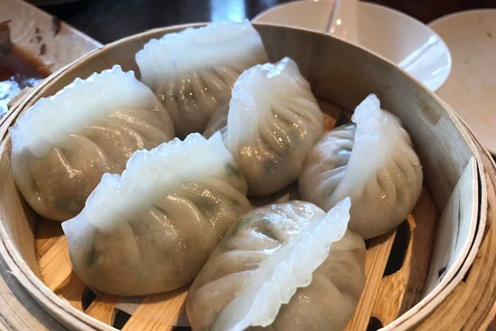 Har gow dumplings nestled in a steaming basket.