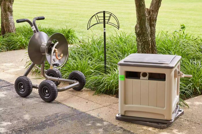 A trio of premium hose reels positioned in an outdoor garden setting