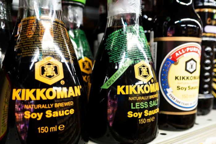Bottles of soy sauce displayed on a grocery store shelf.