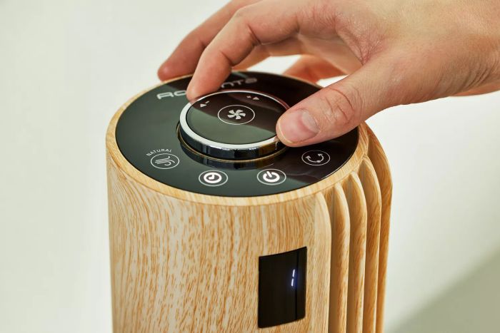 A hand adjusting the knob on the Rowenta Urban Cool Silent Tower Fan