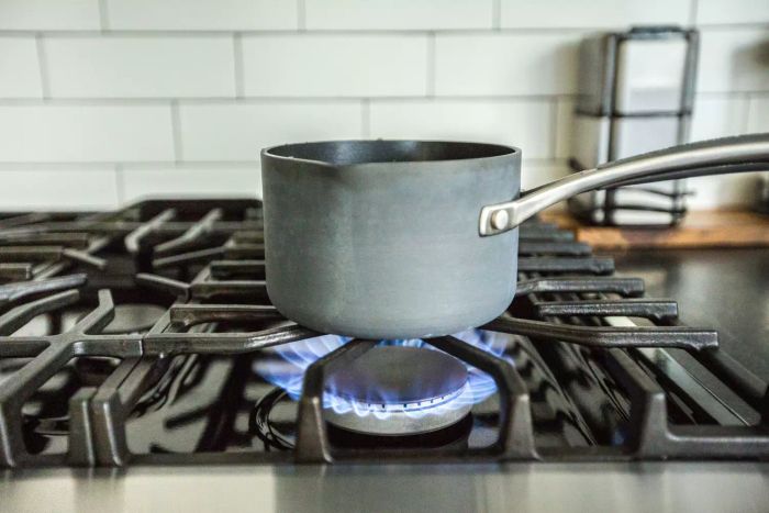 A gas stove flame burning on a stovetop
