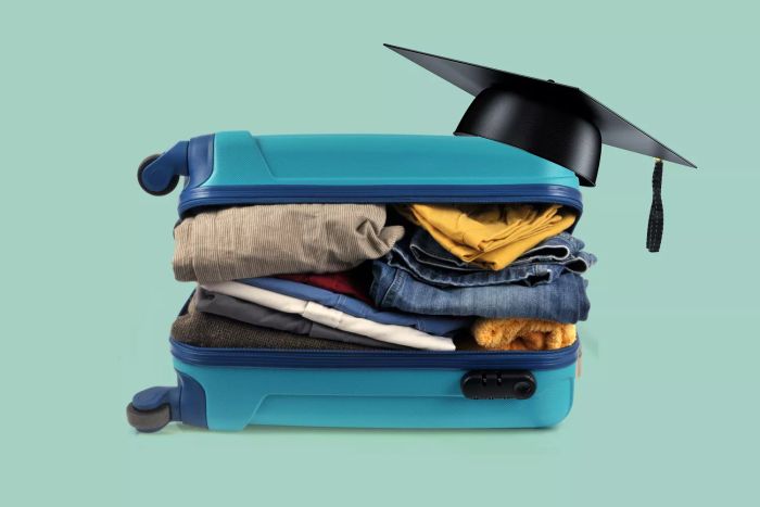 Suitcase with graduation cap