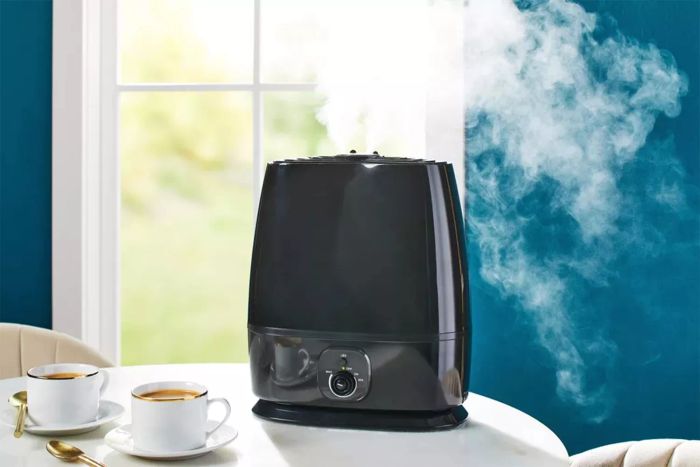 A humidifier in action, placed on a dining room table.