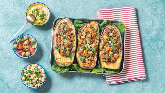 Eggplant filled with vegetables and cooked in a pan.