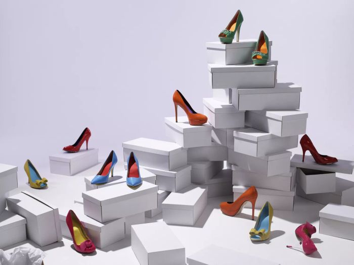 Colorful high heels arranged neatly on white shoe boxes.