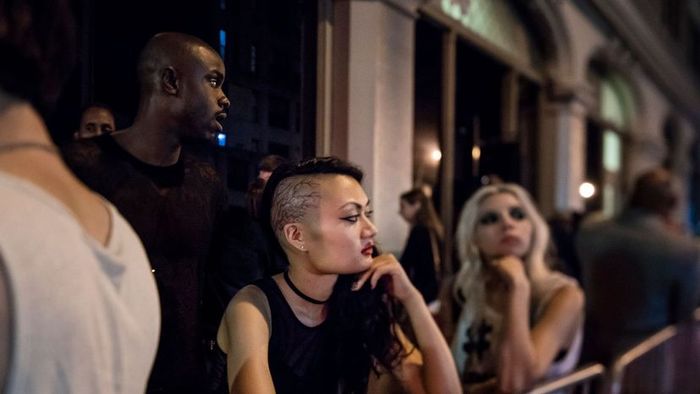 a group of people waiting outside a club