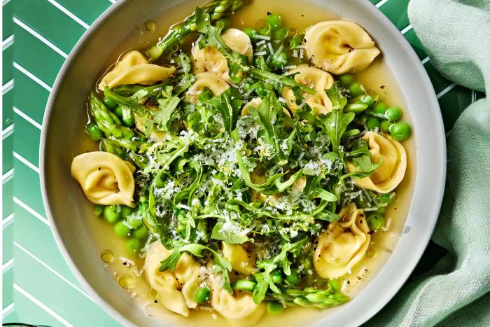 Tortellini served with vegetables in a savory broth