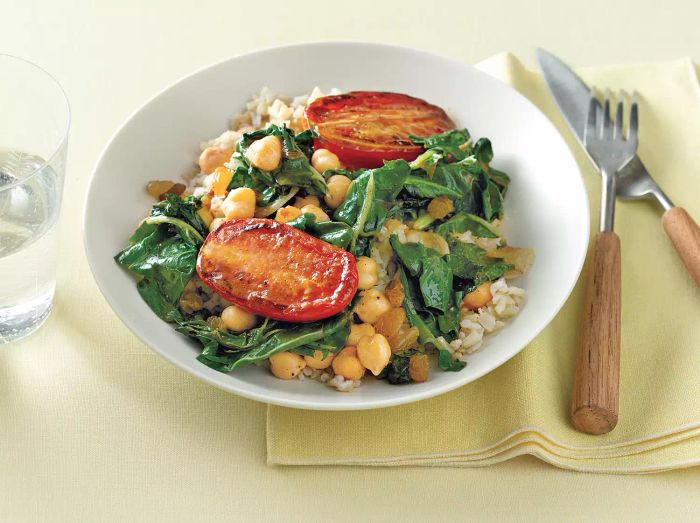 A hearty dish featuring chickpeas, chard, and pan-roasted tomatoes, perfect for a nutritious meal.