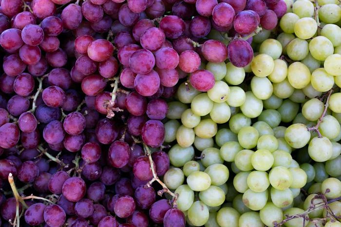 bunches of red and green grapes side-by-side