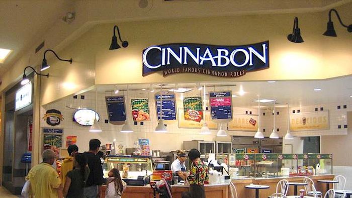 A typical Cinnabon store, often found in the bustling corridors of shopping malls.