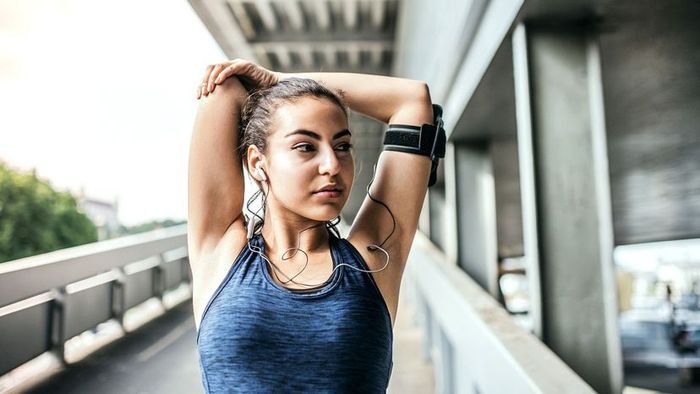 A female runner pausing to catch her breath